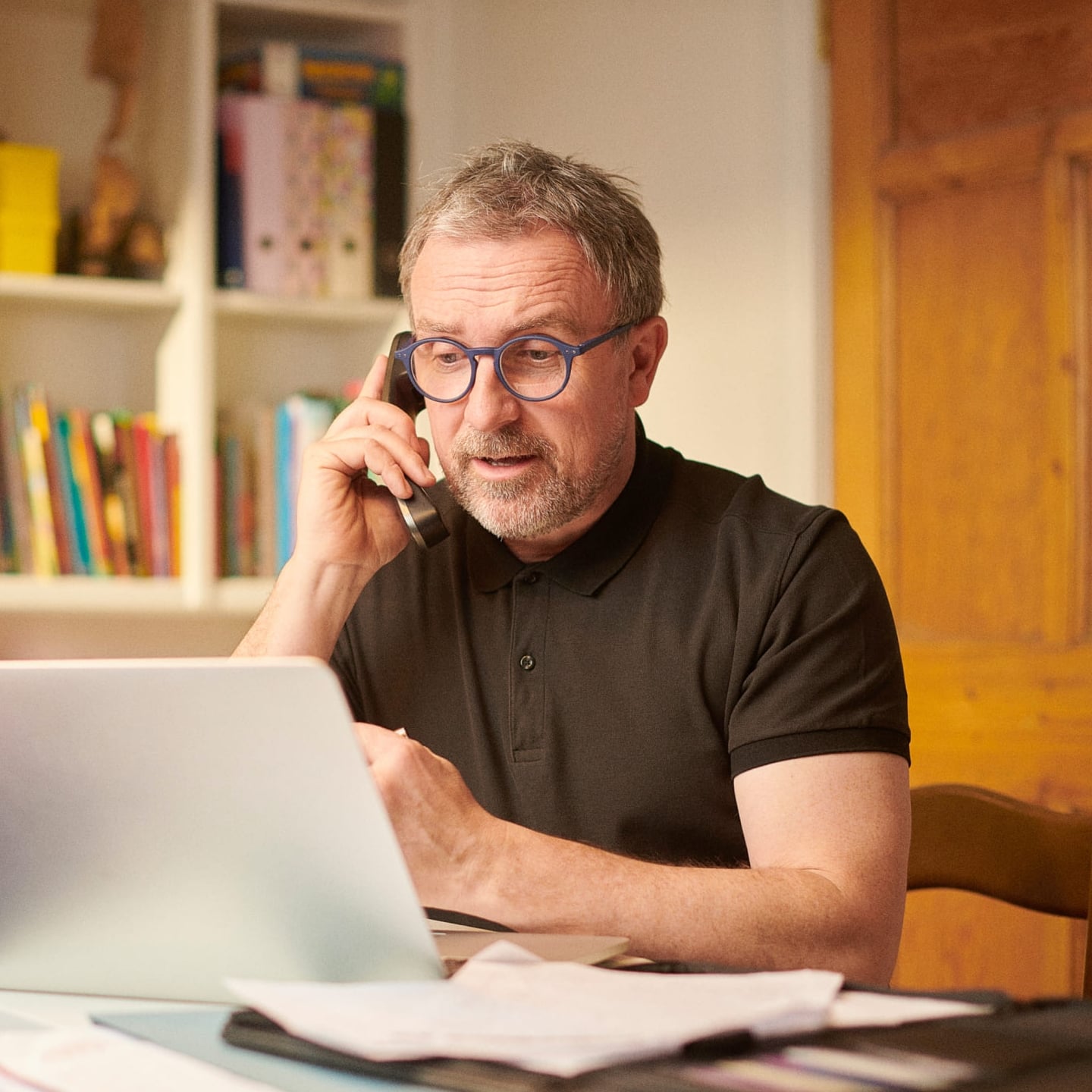 husband renewing his insurance policy at home