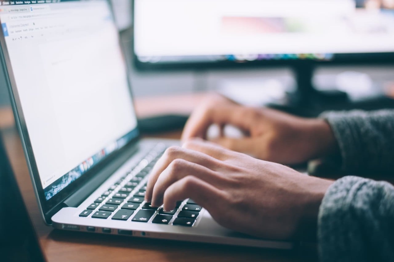 Allianz customer researching home insurance benefits on laptop