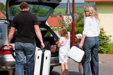 Family packing car with suitcase