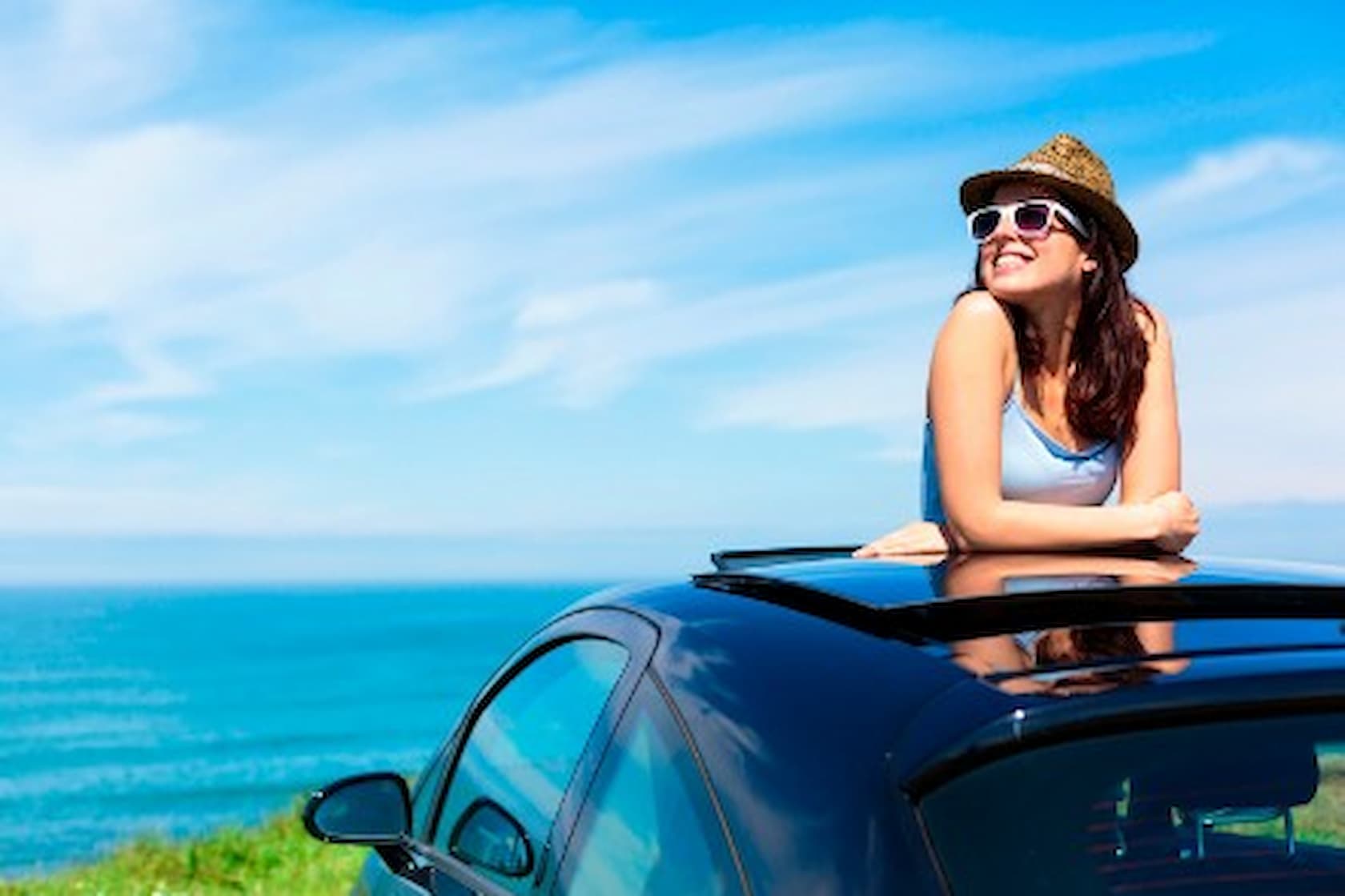 Girl standing out of sun roof
