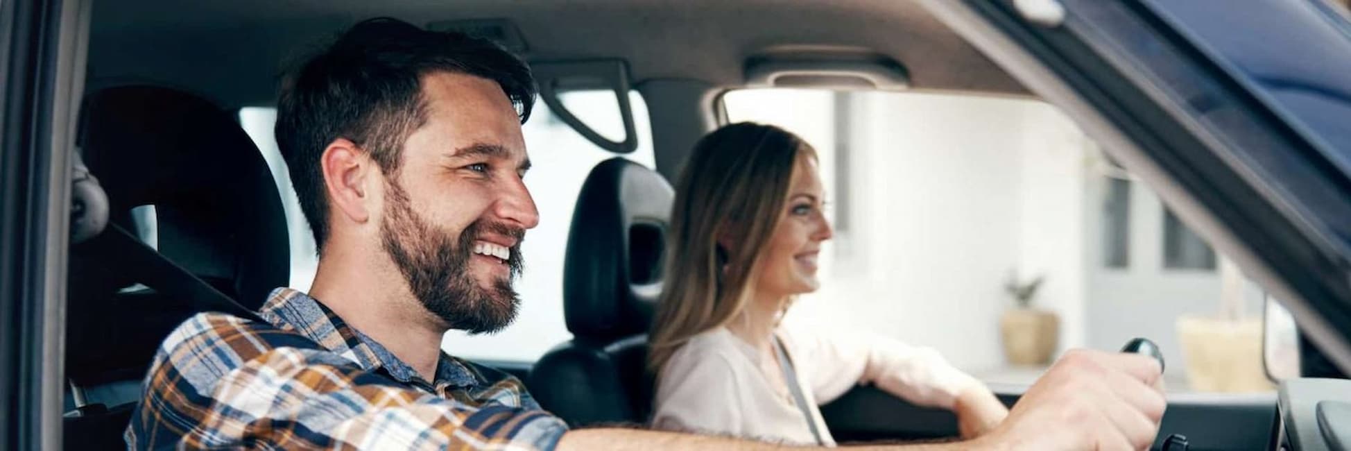 man and woman smiling in car