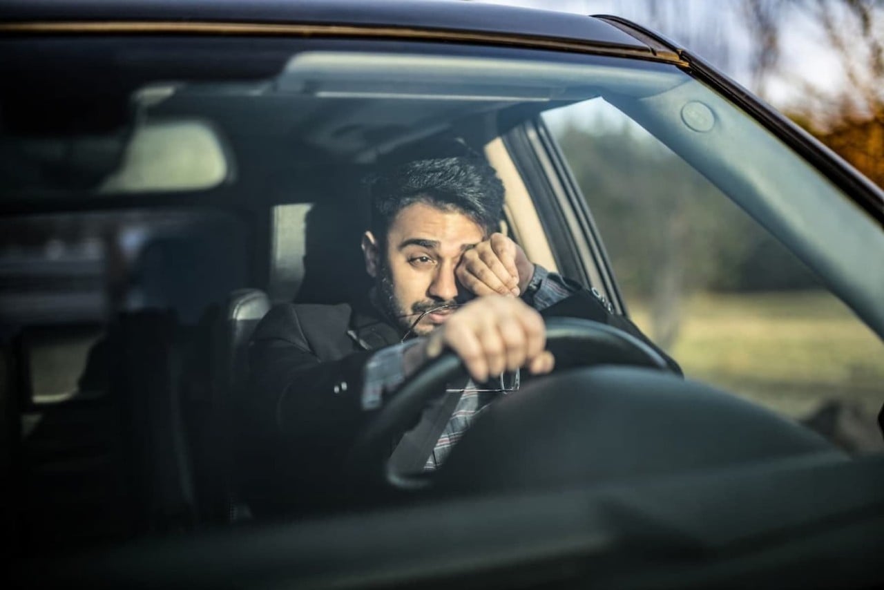 man driving car