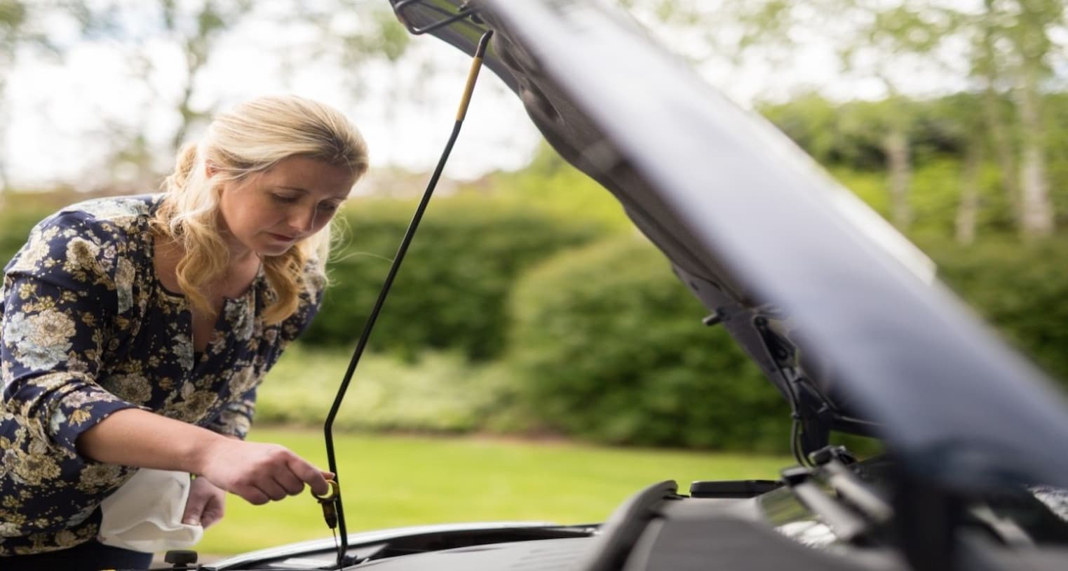 woman checking the engine oil