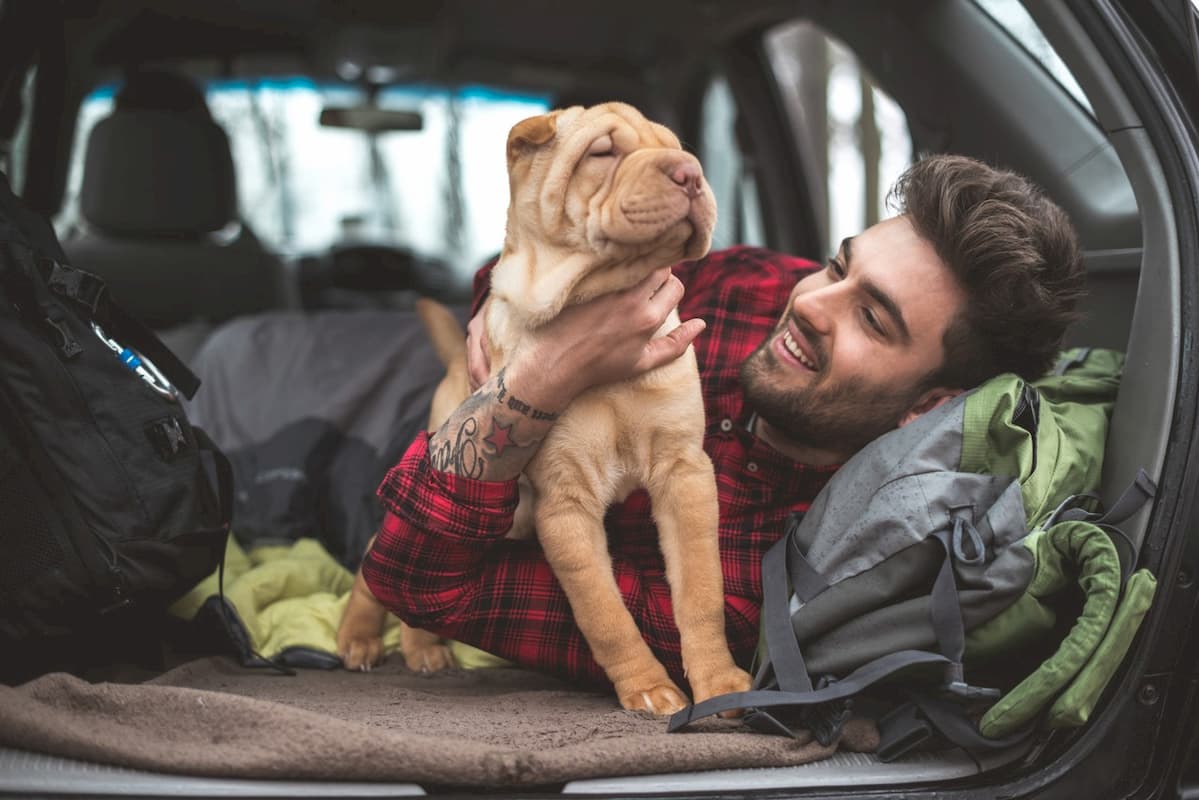 Young man smiling at dog