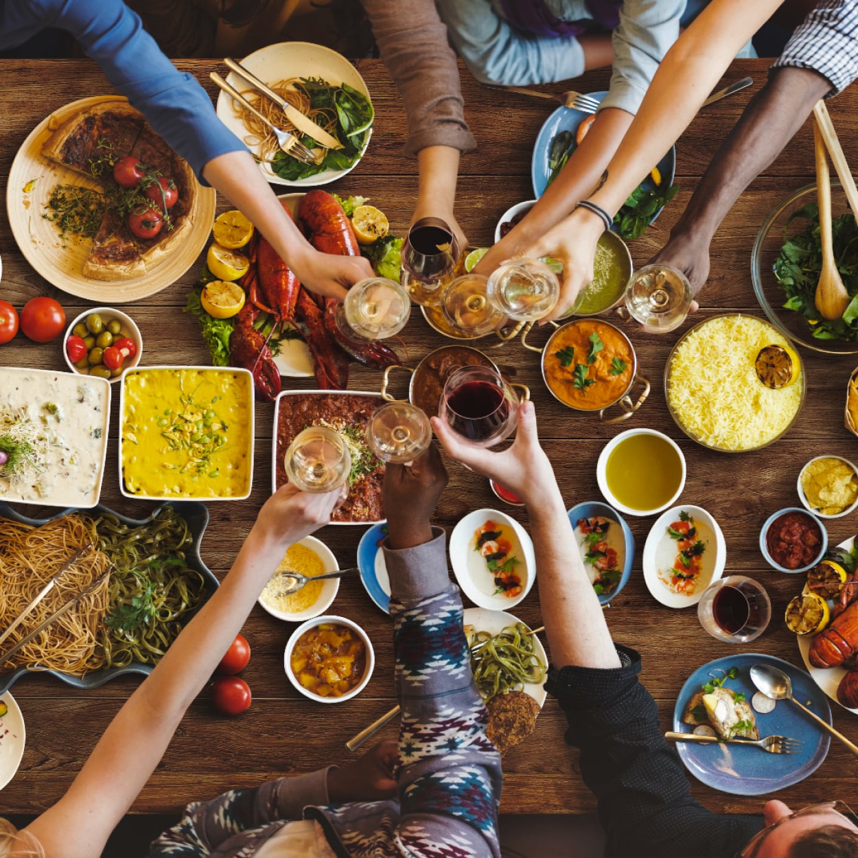 Toasting over a table with food