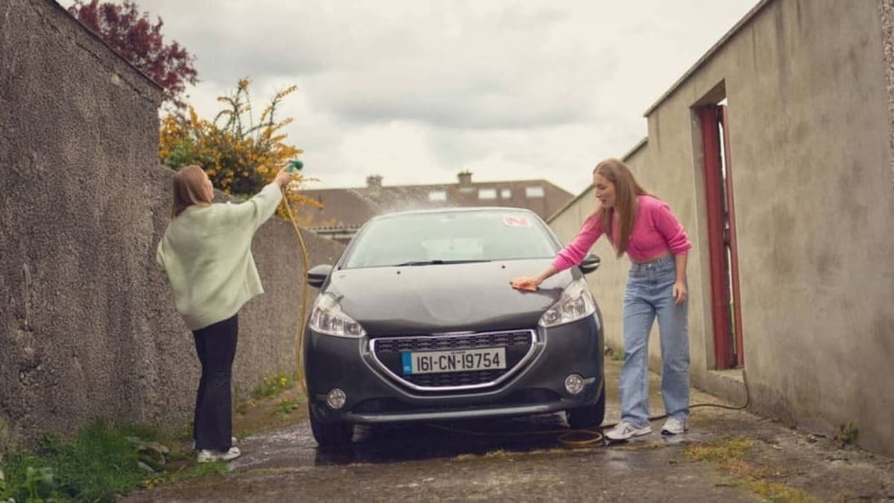 young drivers washing a car
