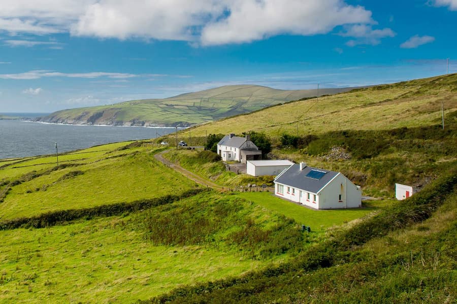 Cottages on cliffs beside Irish sea
