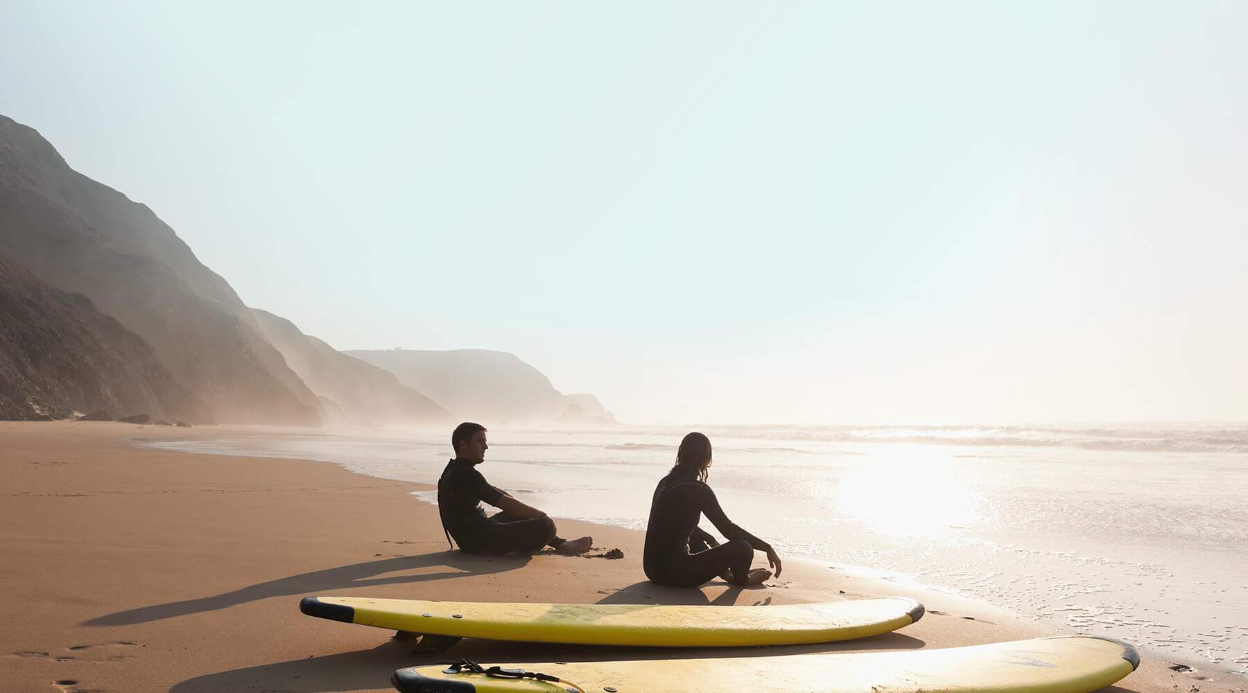 Surfers on sunny beach